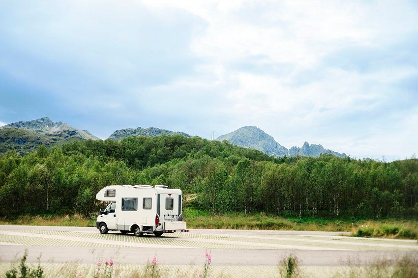 caravan-on-mountain-road-against-sky-U78ZCZV.jpg